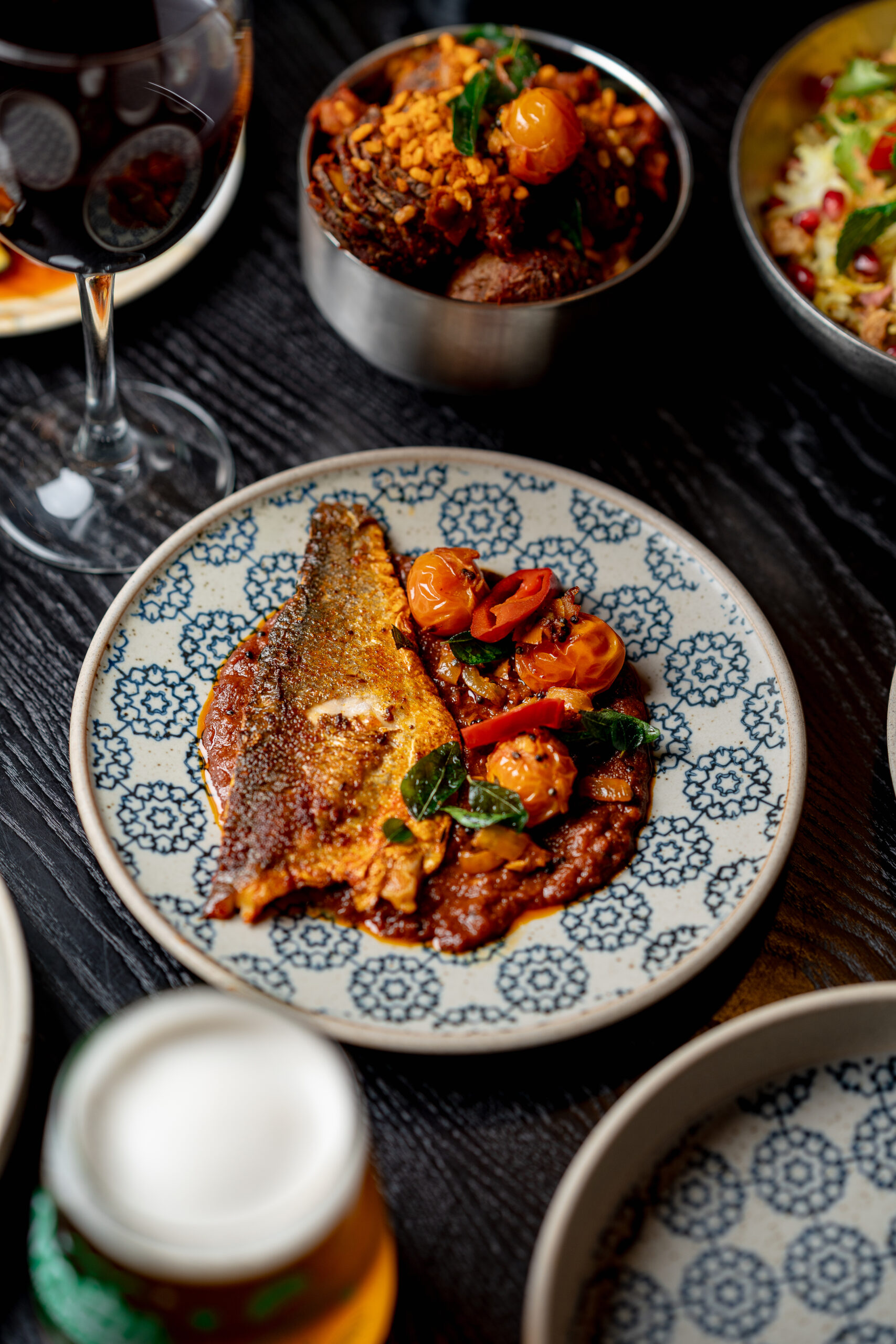 Seared sea bass served in a tangy cherry tomato masala base at Kerala Canteen in Leeds.