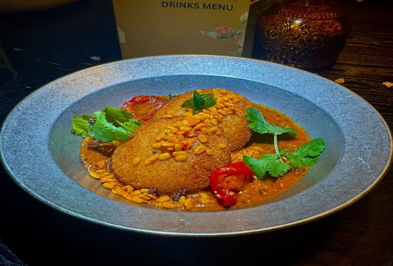 South Indian curry dish with crispy lentil fritters