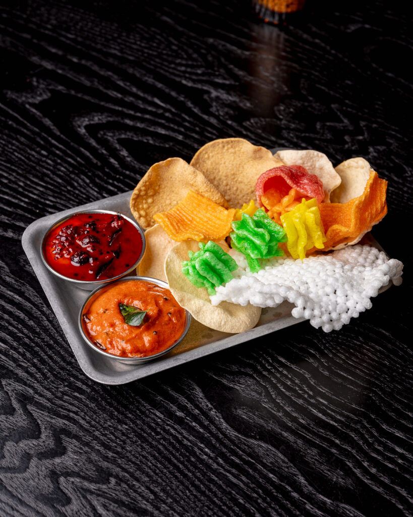 Poppadom Tray at Kerala Canteen Leeds with coloured rice poppadom, lentil poppadom, tomato chutney and seasonal berries achar