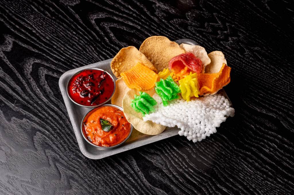 Poppadom Tray at Kerala Canteen Leeds with coloured rice poppadom, lentil poppadom, tomato chutney and seasonal berries achar