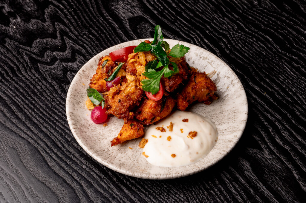 Trivandrum Fried Chicken at Kerala Canteen Leeds served with fried garlic yoghurt and South Indian spices