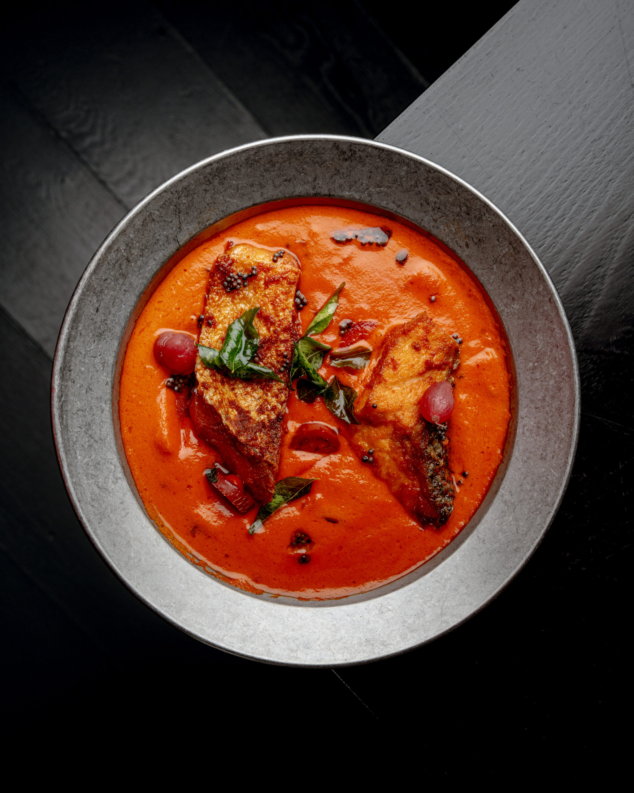 Skin-on salmon served in green mango coconut curry at Kerala Canteen Leeds