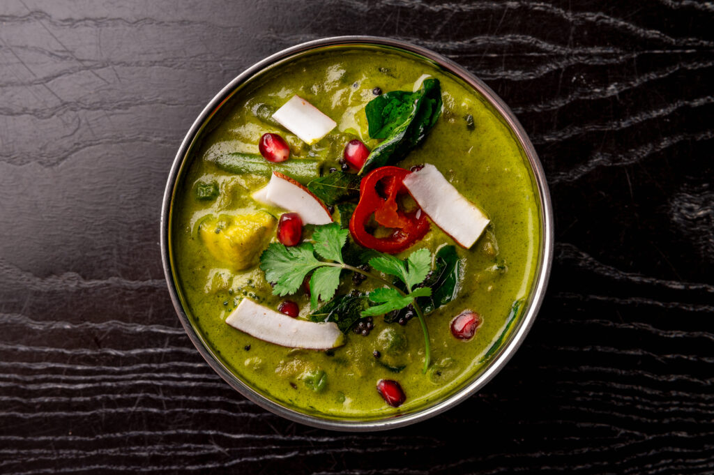Green Seasonal Vegetable Korma with broccoli, peas, beans and courgettes at Kerala Canteen in Leeds