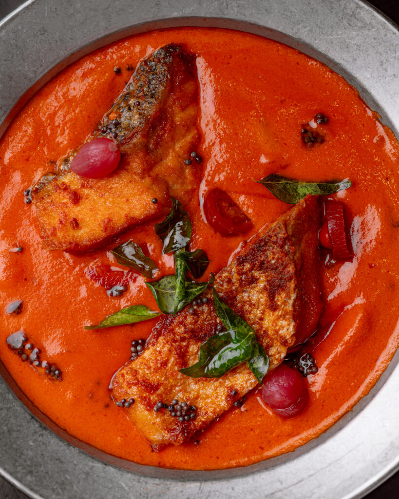 Salmon Green Mango Curry with skin-on salmon in green mango coconut curry at Kerala Canteen Leeds