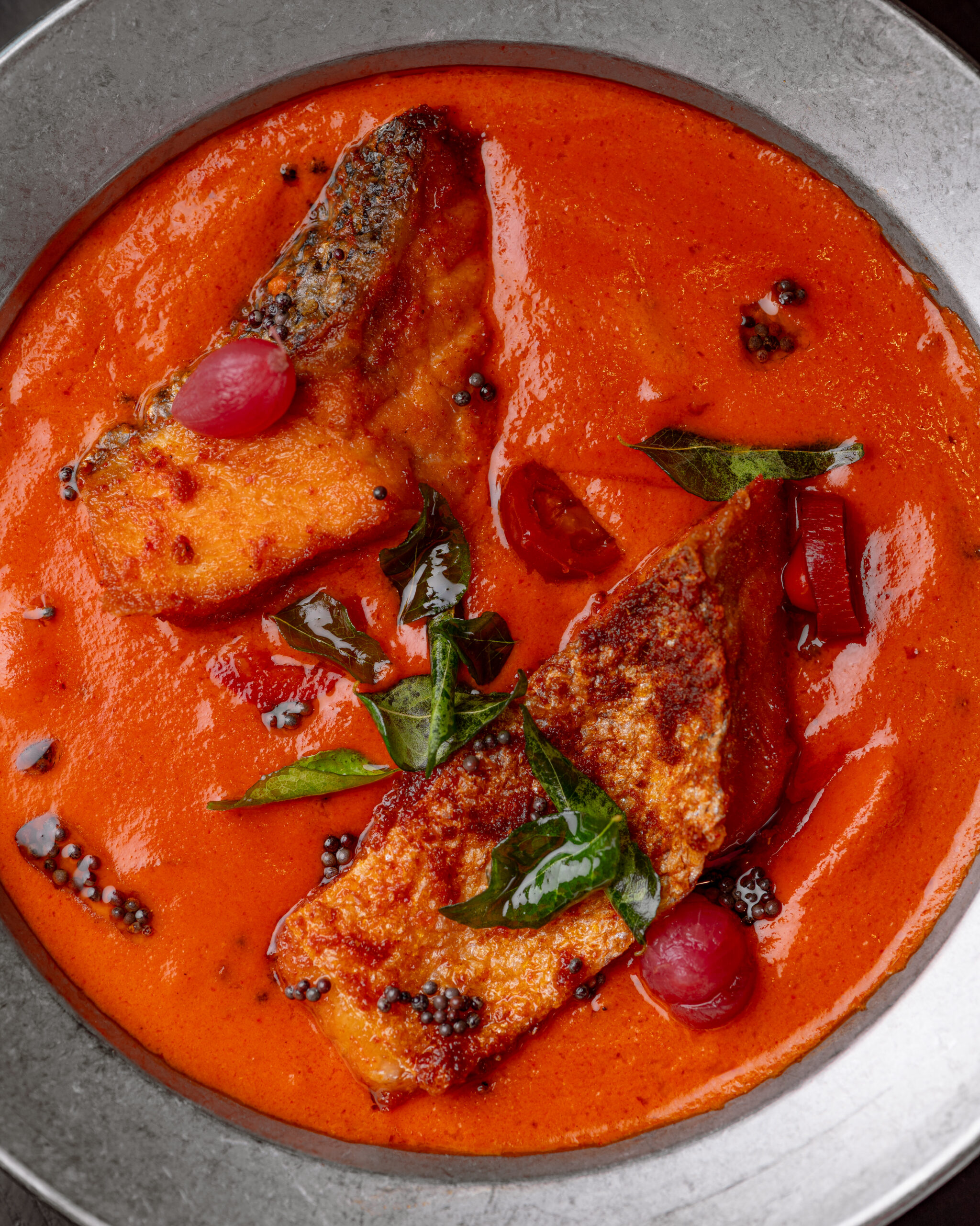 Salmon Green Mango Curry with skin-on salmon in green mango coconut curry at Kerala Canteen Leeds